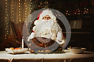 Santa Claus opening a magical presentSanta Claus sitting at a table, eating a turkey