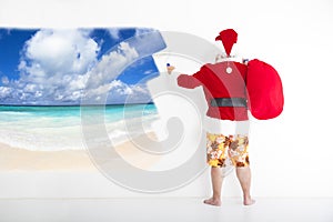 Santa claus painting vacation concept on wall