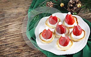 Santa Claus pancakes with whipped cream and strawberries, Christmas food idea