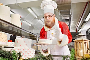 Santa Claus a pastry cooks a cake in the kitchen on Christmas Da