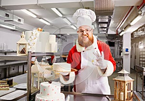 Santa Claus a pastry cooks a cake in the kitchen on Christmas Da