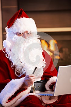 Santa Claus paying with credit card