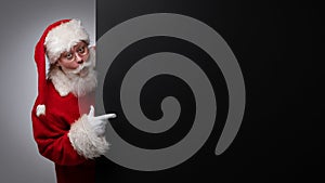 Santa Claus pointing black billboard