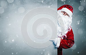 Santa Claus pointing on blank advertisement banner