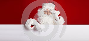 Santa Claus pointing in blank advertisement banner isolated on r