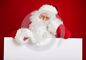 Santa Claus pointing in blank advertisement banner isolated on r