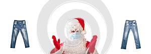 Santa Claus pointing at two pairs of light blue jeans isolated on white background. Jeans have white faded spots and ripped holes