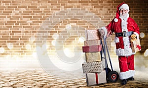 Santa Claus with presents on a delivery trolley in a postal theme with festive lighting and an industrial background