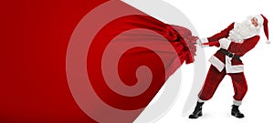 Santa Claus pulling enormous red bag full of Christmas gifts on white background. Banner design