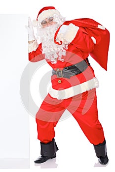 Santa Claus pushes blank white wall, advertisement banner with copy space. Isolated on white background. Full length