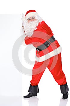 Santa Claus pushes blank white wall, advertisement banner with copy space. on white background. Full length