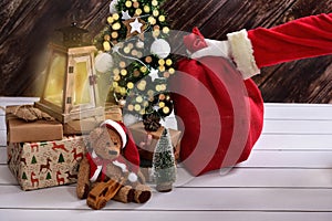 Santa claus putting secretly gift sack under the christmas tree