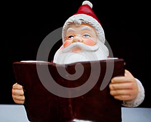 Santa Claus reading a book