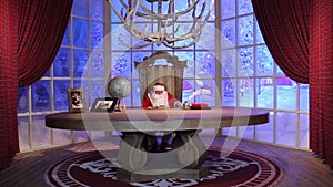 Santa Claus is reading a book in his residence