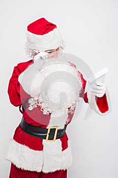 Santa Claus Reading Letter isolated over white baclground