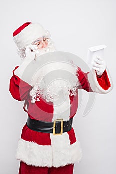 Santa Claus Reading Letter isolated over white baclground