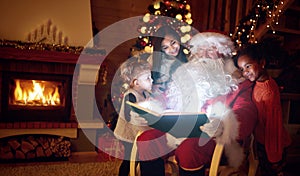 Santa Claus reading magic book with children