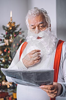 Santa claus reading newspaper