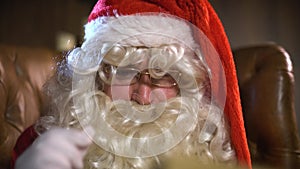 Santa Claus Reading Old Book or album.