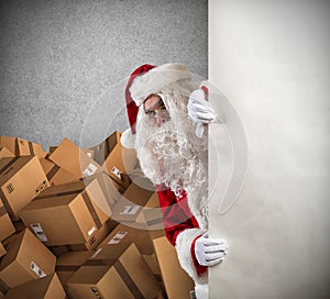 Santa Claus ready to deliver a lot of Christmas presents package