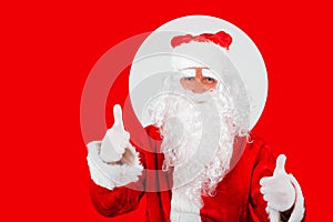 Santa Claus on red background makes thumbs up