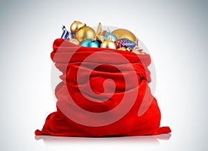 Santa Claus red bag with Christmas toys on background.