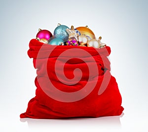 Santa Claus red bag with Christmas toys on background.