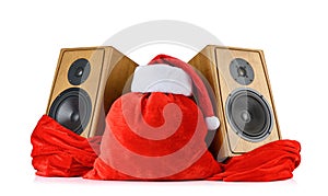 Santa Claus red hat and bag, with two wooden speaker on white background. File contains a path to isolation.