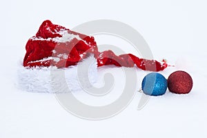 Santa Claus red hat with balls on white snow
