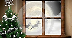 Santa claus and reindeer flying over moon, window view