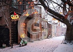 Santa Claus reindeer sleigh Christmas decorations hanging outside a Philadelphia rowhouse in Queen Village in the snow