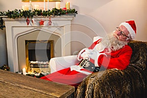 Santa claus relaxing on sofa in living room at home