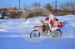 Santa Claus riding on a bike MX through deep snow