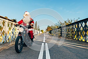 Santa claus riding a motorcycle on the road