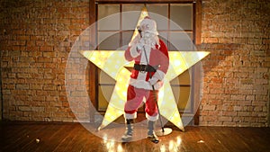 Santa Claus rock star, dances, sings funny christmas songs in retro microphone