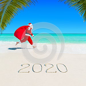 Santa Claus run at sandy ocean beach 2020 with Christmas sack