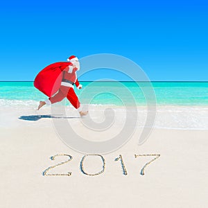 Santa Claus run at tropical beach 2017 with Christmas sack