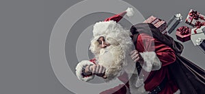 Santa Claus running and delivering gifts photo