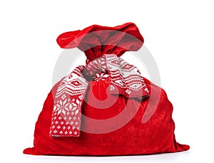 Santa Claus`s red bag full with gift, tied scarf, isolated on white background. File contains a path to isolation.
