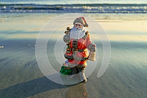 Santa Claus on sea beach. Happy New Year and merry Christmas travel, tropical vacations concept.