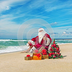 Santa Claus at sea beach with many gifts and decorated christmas