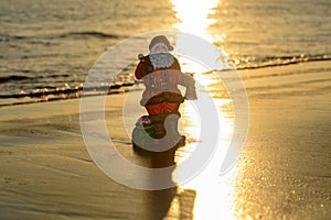 Santa Claus on sea sunset beach. Happy New Year and merry Christmas travel, tropical vacations concept.