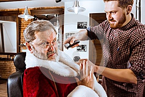 Santa claus shaving his personal barber