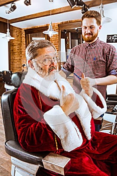 Santa claus shaving his personal barber