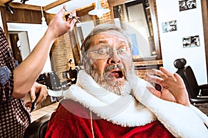 Santa claus shaving his personal barber