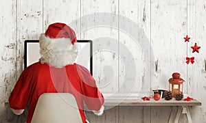 Santa Claus shopping on computer. Christmas sale time. Free space for text