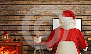 Santa Claus shopping online on computer from his warm room