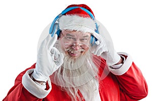 Santa claus showing hand okay sign while listening to music on headphones