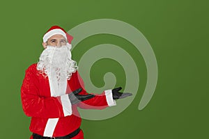 Santa Claus showing something in an empty space