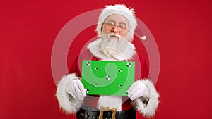 Santa Claus Shows an Approving Thumbs-up Gesture With Space for Text or Advertising on Red. Cheerful Santa Claus Holding